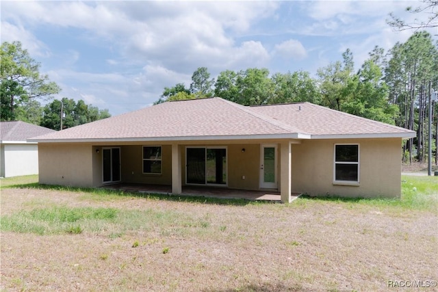 97 W Camino Ln, Citrus Springs, FL 34434 - back of house with a patio, roof with shingles, and stucco siding