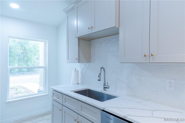 97 W Camino Ln, Citrus Springs, FL 34434 - kitchen featuring a sink, light stone counters, tasteful backsplash, and baseboards