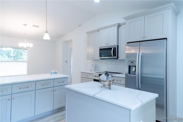 97 W Camino Ln, Citrus Springs, FL 34434 - kitchen featuring decorative backsplash, light stone countertops, appliances with stainless steel finishes, a notable chandelier, and vaulted ceiling