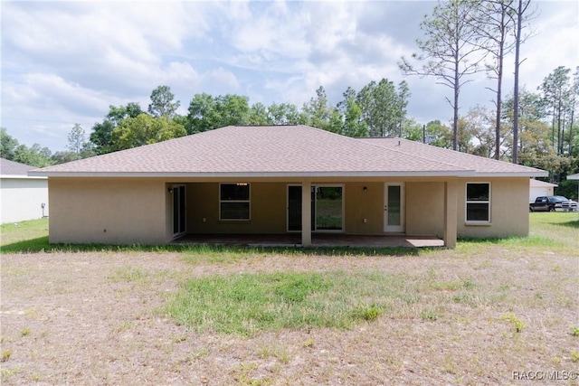 97 W Camino Ln, Citrus Springs, FL 34434 - back of house with a patio area, stucco siding, and roof with shingles