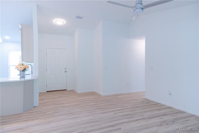 97 W Camino Ln, Citrus Springs, FL 34434 - spare room featuring a ceiling fan, baseboards, and light wood-style flooring