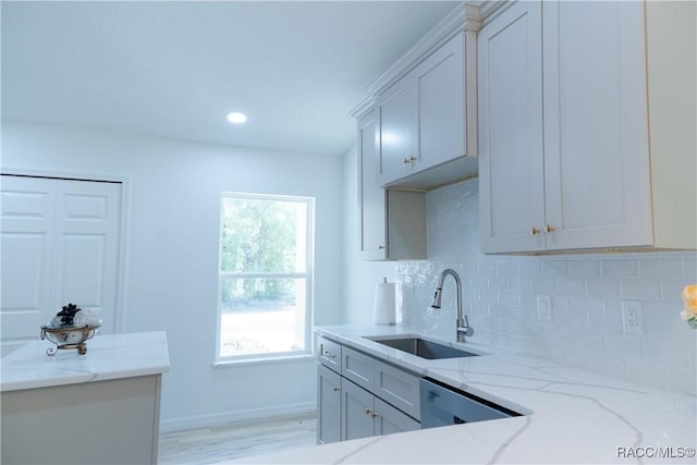 97 W Camino Ln, Citrus Springs, FL 34434 - kitchen featuring decorative backsplash, a sink, light stone counters, baseboards, and dishwashing machine