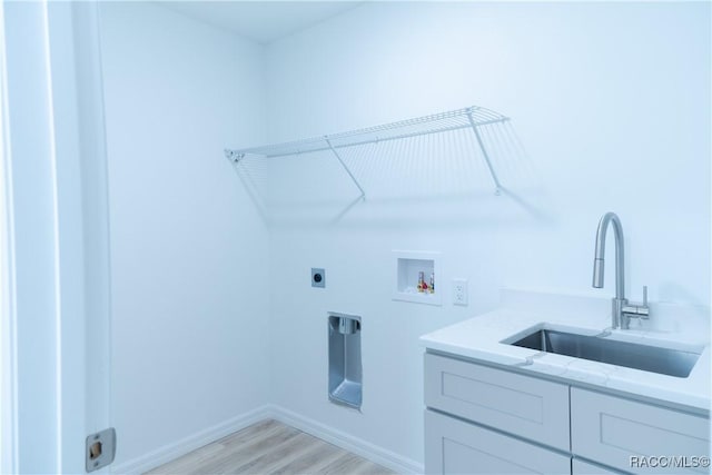 97 W Camino Ln, Citrus Springs, FL 34434 - washroom with cabinet space, washer hookup, a sink, light wood finished floors, and electric dryer hookup