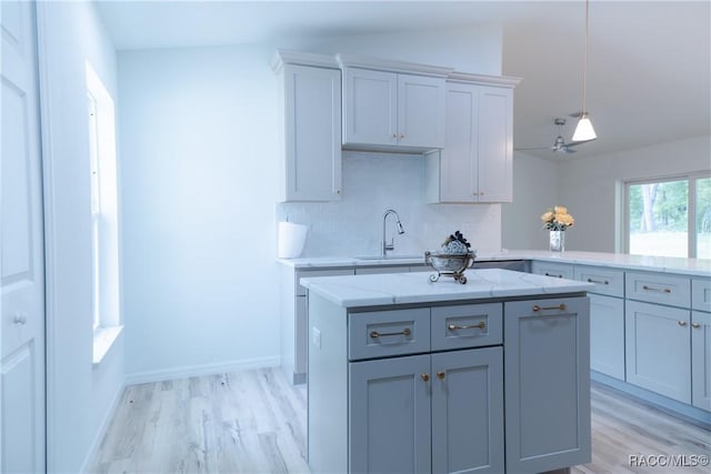 97 W Camino Ln, Citrus Springs, FL 34434 - kitchen with a sink, light stone counters, decorative backsplash, and light wood finished floors