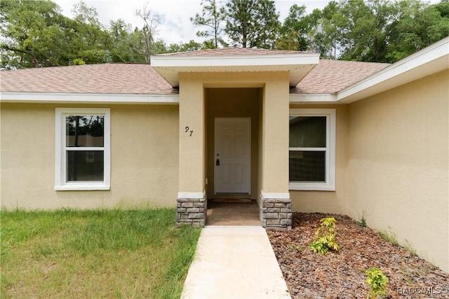 97 W Camino Ln, Citrus Springs, FL 34434 - property entrance featuring roof with shingles and stucco siding