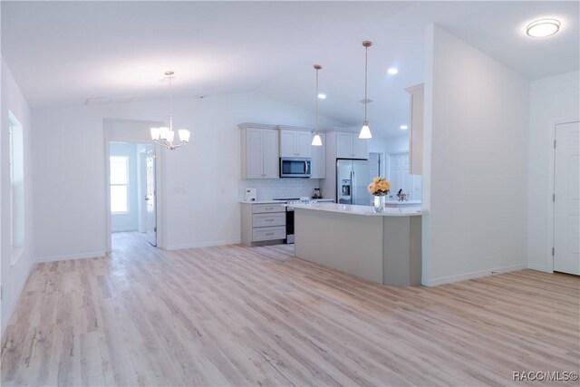 97 W Camino Ln, Citrus Springs, FL 34434 - kitchen featuring appliances with stainless steel finishes, vaulted ceiling, light wood finished floors, and a notable chandelier