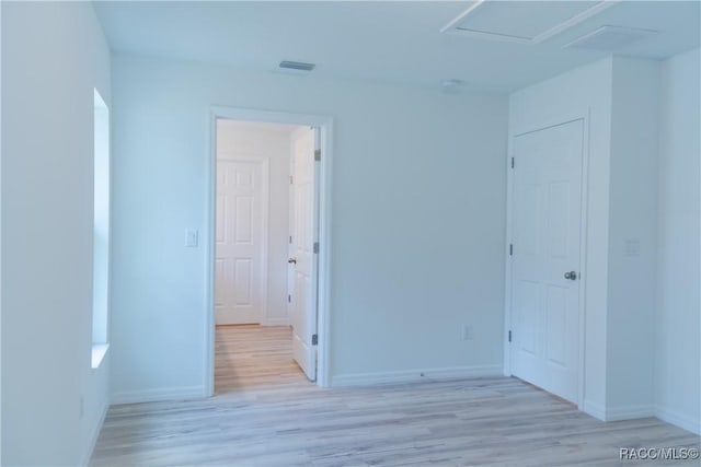 97 W Camino Ln, Citrus Springs, FL 34434 - empty room featuring baseboards, attic access, and light wood-style flooring