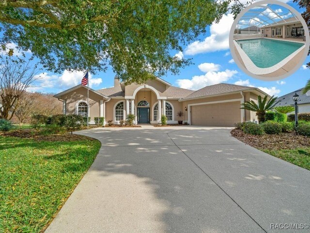 view of front facade featuring a front yard and a garage