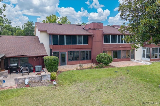688 Midway Dr Unit B, Ocala, FL 34472 - rear view of house with a patio area, a lawn, cooling unit, and a shingled roof