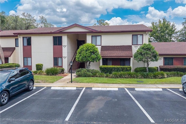 688 Midway Dr Unit B, Ocala, FL 34472 - view of building exterior with uncovered parking and stairway