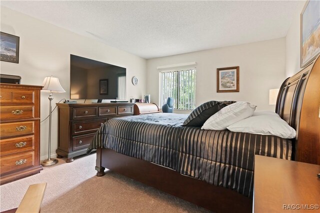 688 Midway Dr Unit B, Ocala, FL 34472 - bedroom featuring light carpet and a textured ceiling