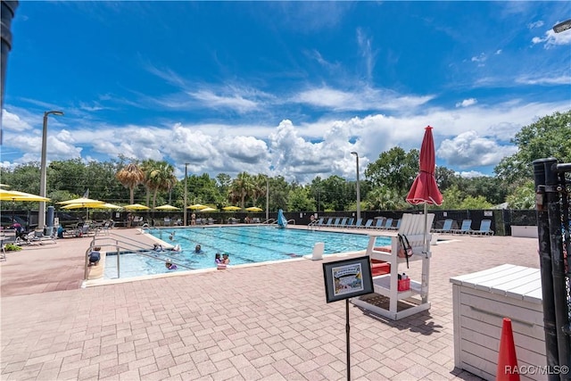 688 Midway Dr Unit B, Ocala, FL 34472 - community pool featuring a patio area and view of wooded area
