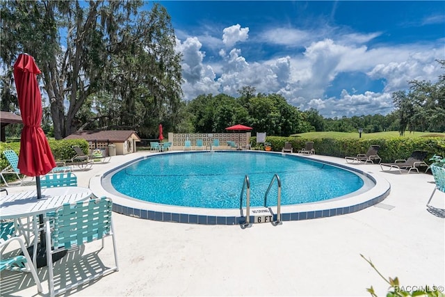 688 Midway Dr Unit B, Ocala, FL 34472 - community pool featuring a patio area and view of wooded area