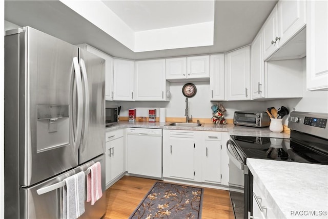 688 Midway Dr Unit B, Ocala, FL 34472 - kitchen with appliances with stainless steel finishes, a sink, light countertops, and white cabinets