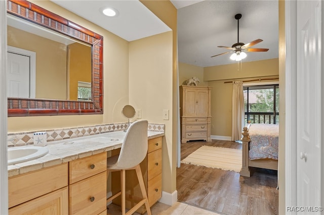 5155 S Gray Pelican Way, Homosassa, FL 34448 - ensuite bathroom with vanity, a ceiling fan, and wood finished floors