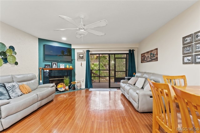 5155 S Gray Pelican Way, Homosassa, FL 34448 - living area featuring wood finished floors, a ceiling fan, and a tiled fireplace