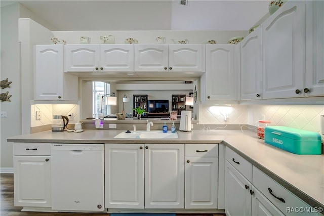 kitchen featuring white cabinetry, white dishwasher, tasteful backsplash, and sink