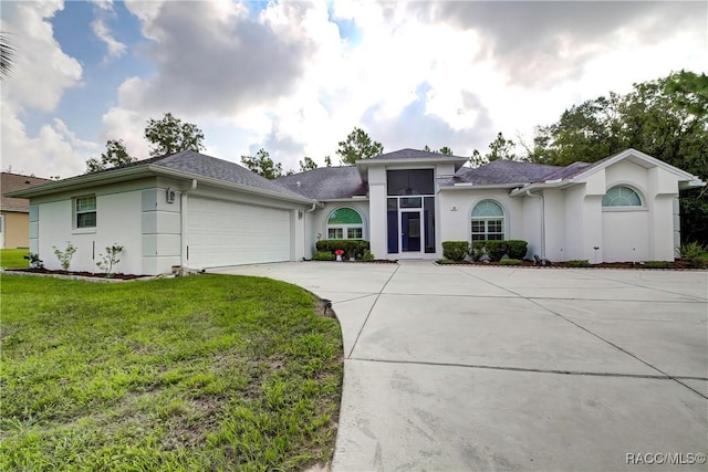 ranch-style home with a front lawn and a garage