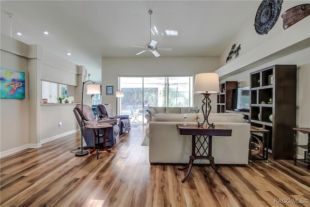 living room featuring hardwood / wood-style flooring and ceiling fan