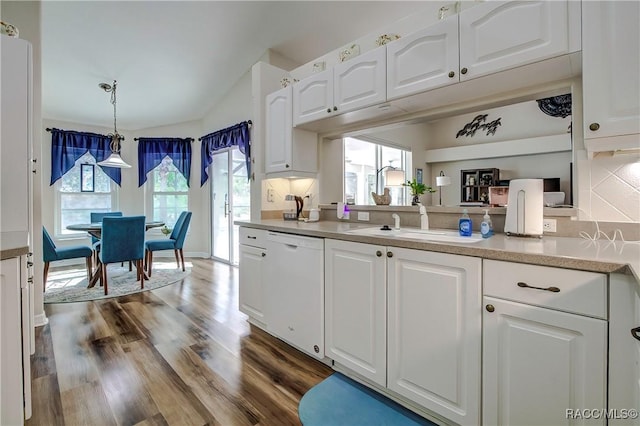 kitchen featuring white cabinetry, hanging light fixtures, dark hardwood / wood-style flooring, sink, and dishwasher