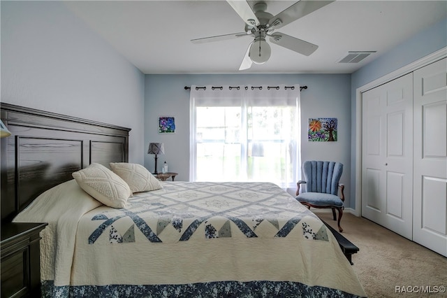 carpeted bedroom featuring a closet and ceiling fan