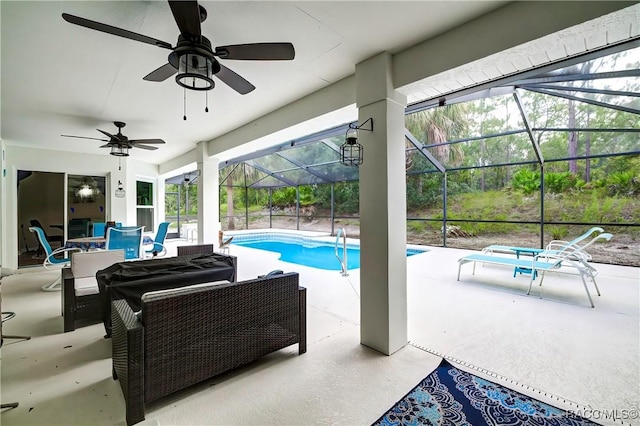 view of pool with a patio, ceiling fan, a lanai, and an outdoor hangout area