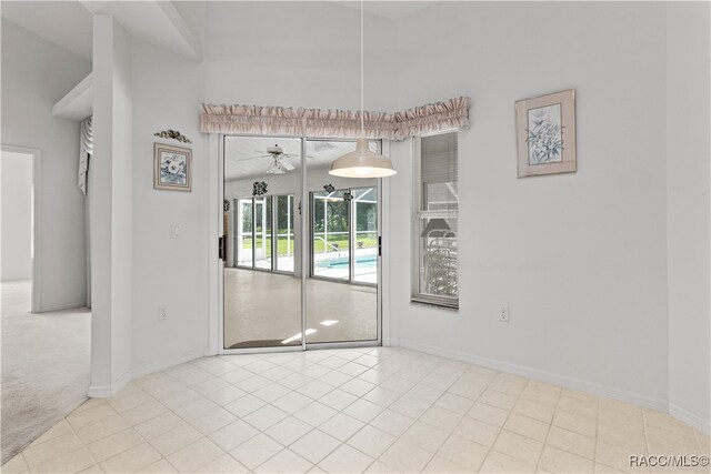 empty room featuring ceiling fan and light carpet