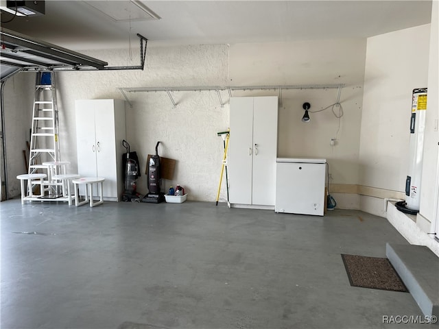 garage with refrigerator, a garage door opener, and water heater