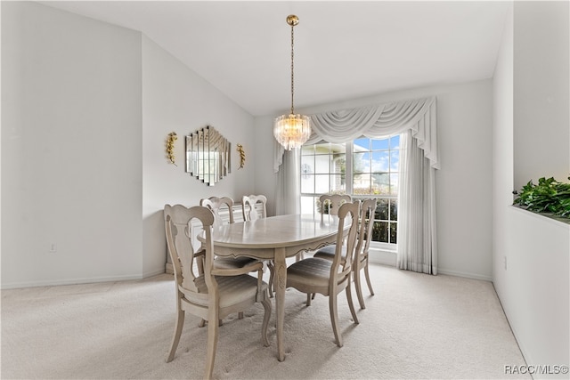 carpeted dining room featuring a chandelier and lofted ceiling