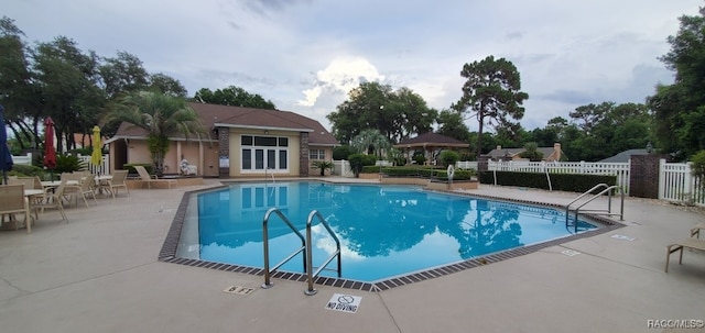 view of swimming pool with a gazebo and a patio area