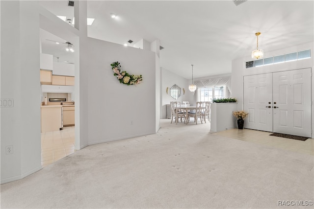 entrance foyer with light colored carpet and a high ceiling