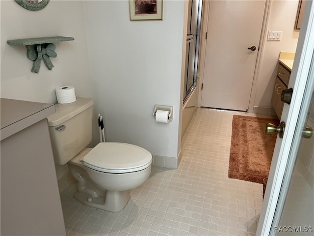 full bathroom with tile patterned floors, vanity, toilet, and enclosed tub / shower combo