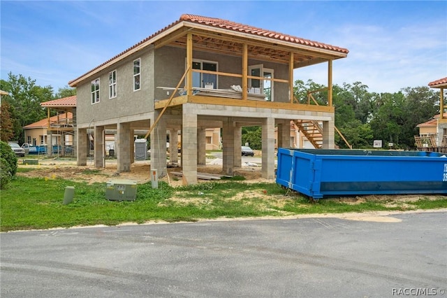 rear view of property featuring a balcony