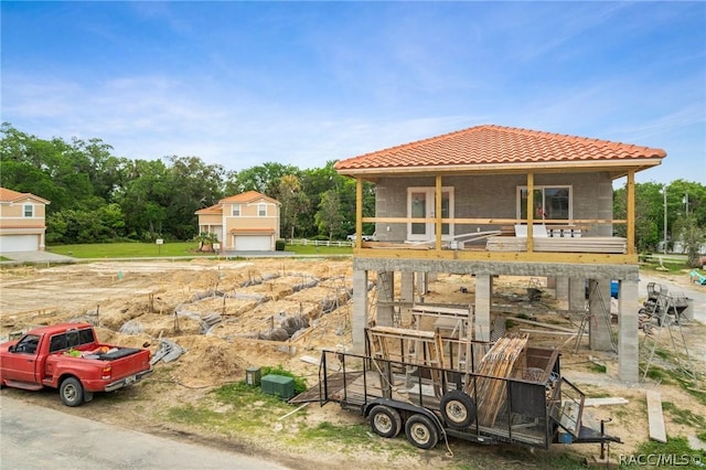 view of front of property with a porch and a garage