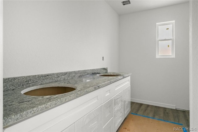 bathroom with hardwood / wood-style flooring and sink