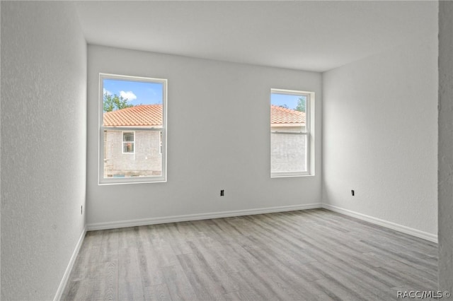 unfurnished room featuring light hardwood / wood-style floors