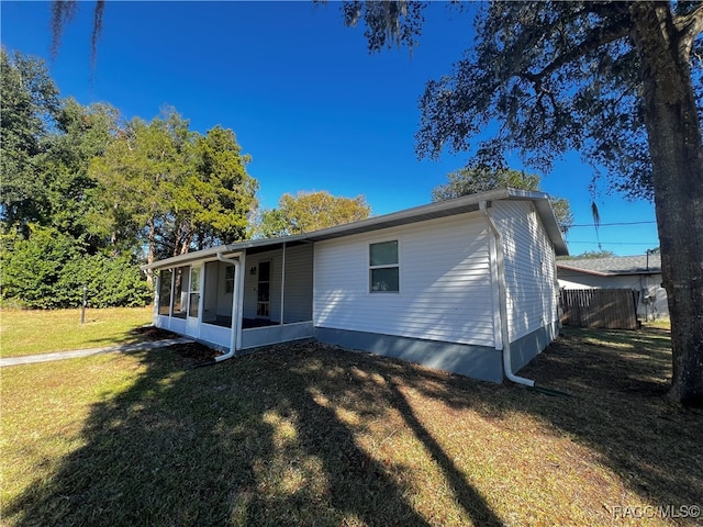 rear view of house with a yard