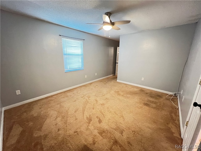 unfurnished room with carpet flooring, a textured ceiling, and ceiling fan