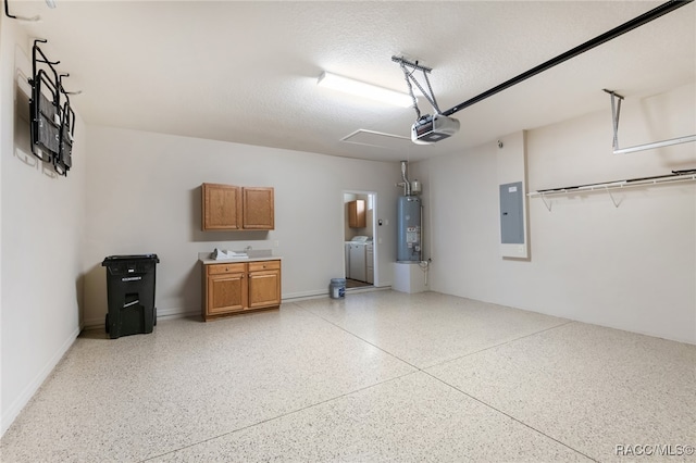 garage featuring electric panel, gas water heater, independent washer and dryer, and a garage door opener