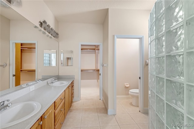 bathroom with tile patterned flooring, vanity, and toilet