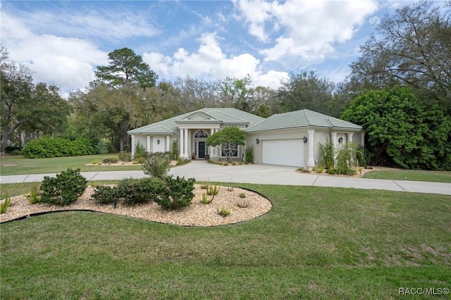 view of front facade with a tile roof, stucco siding, a garage, driveway, and a front lawn