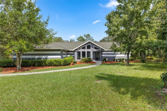 ranch-style home with a front lawn