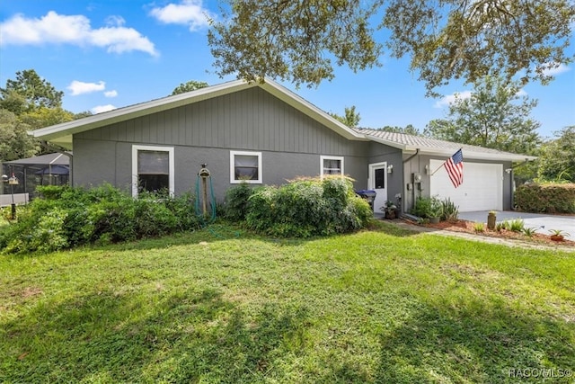 view of front of property with a front yard and a garage