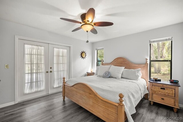 bedroom with french doors, dark hardwood / wood-style flooring, multiple windows, and access to outside