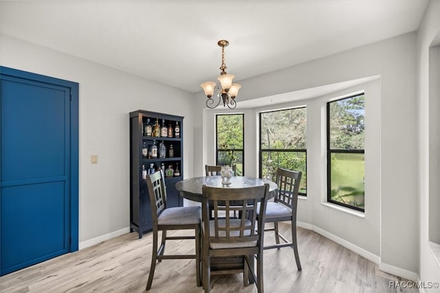 dining area featuring an inviting chandelier and light wood-type flooring