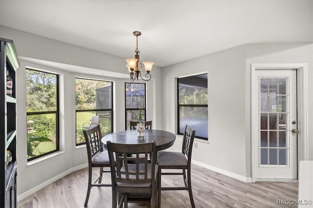 dining room with an inviting chandelier and light hardwood / wood-style floors