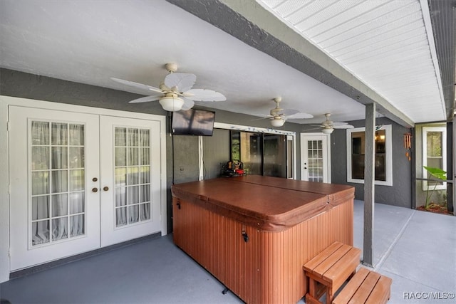 view of patio / terrace featuring a hot tub, french doors, and ceiling fan