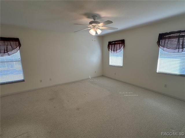 carpeted empty room with ceiling fan