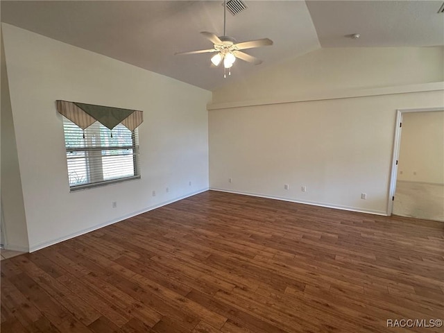 empty room with dark wood-type flooring, ceiling fan, and vaulted ceiling