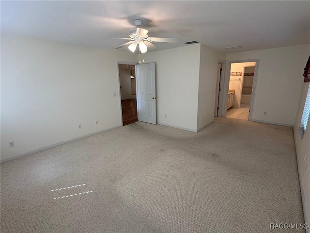 carpeted spare room with ceiling fan